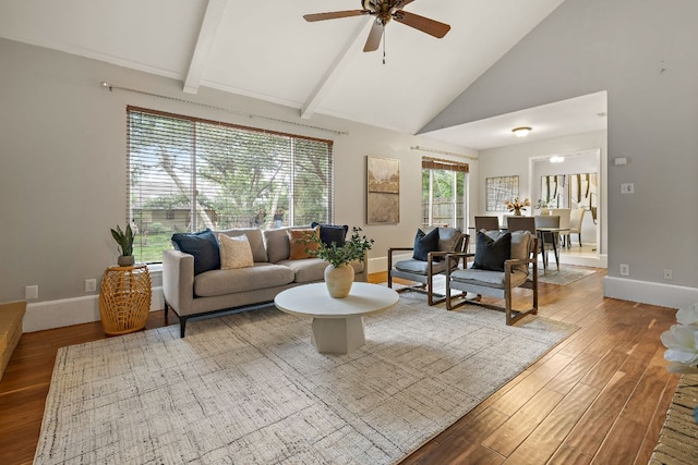 13007 Stillforest St, Austin, TX 78729 - living room with wood finished floors, high vaulted ceiling, baseboards, ceiling fan, and beam ceiling