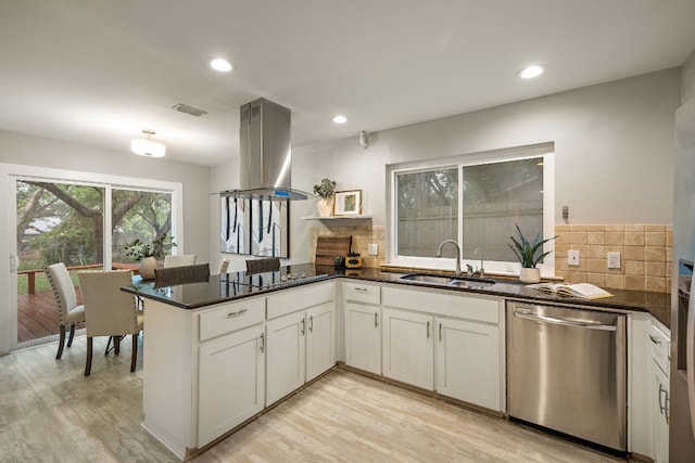 13007 Stillforest St, Austin, TX 78729 - kitchen featuring dishwasher, a sink, island exhaust hood, black electric cooktop, and tasteful backsplash