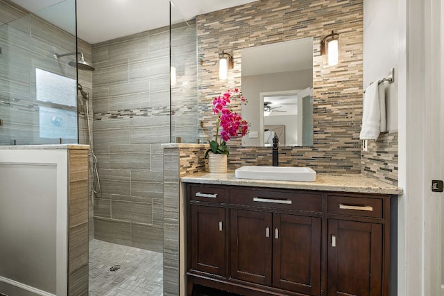 13007 Stillforest St, Austin, TX 78729 - full bath with backsplash, a tile shower, vanity, and a ceiling fan