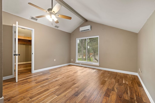 13007 Stillforest St, Austin, TX 78729 - unfurnished bedroom featuring a wall unit AC, wood finished floors, and baseboards