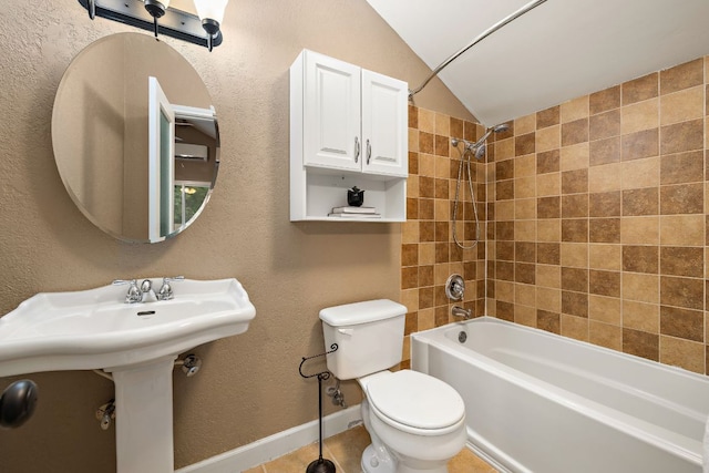 13007 Stillforest St, Austin, TX 78729 - bathroom with toilet, shower / washtub combination, lofted ceiling, a textured wall, and baseboards