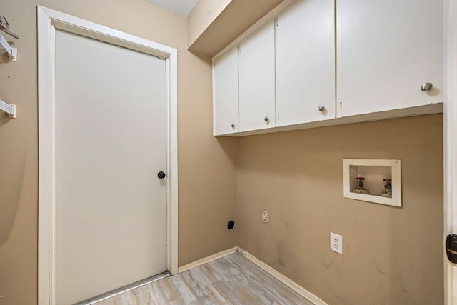 13007 Stillforest St, Austin, TX 78729 - laundry area featuring cabinet space, hookup for a washing machine, light wood finished floors, and baseboards