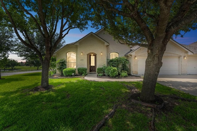 20700 Windmill Ridge St, Pflugerville, TX 78660 - traditional-style home featuring a yard, an attached garage, brick siding, and driveway