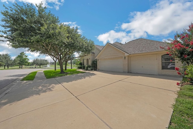 20700 Windmill Ridge St, Pflugerville, TX 78660 - view of front of home featuring concrete driveway, a garage, and brick siding