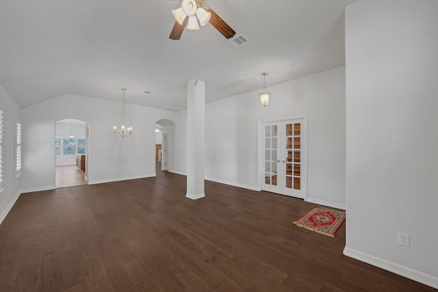 20700 Windmill Ridge St, Pflugerville, TX 78660 - unfurnished living room with arched walkways, a ceiling fan, dark wood finished floors, a chandelier, and lofted ceiling