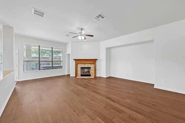20700 Windmill Ridge St, Pflugerville, TX 78660 - unfurnished living room featuring wood finished floors, ceiling fan, and a tile fireplace