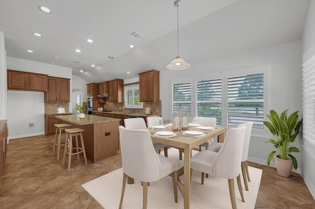 20700 Windmill Ridge St, Pflugerville, TX 78660 - dining room with vaulted ceiling, recessed lighting, and light tile patterned floors