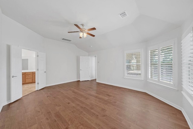 20700 Windmill Ridge St, Pflugerville, TX 78660 - unfurnished bedroom with vaulted ceiling, wood finished floors, connected bathroom, and a ceiling fan