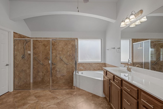 20700 Windmill Ridge St, Pflugerville, TX 78660 - full bath featuring a garden tub, vanity, a stall shower, vaulted ceiling, and ceiling fan