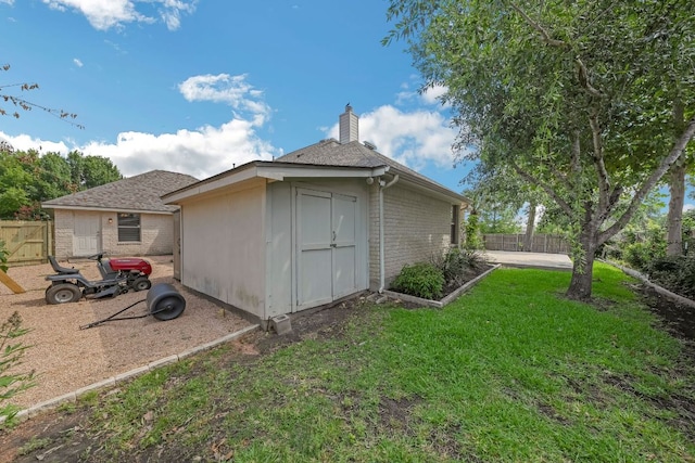20700 Windmill Ridge St, Pflugerville, TX 78660 - view of home's exterior featuring brick siding, a chimney, an outdoor structure, and a shingled roof
