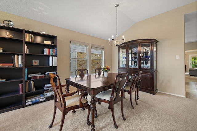 11208 Persimmon Gap Dr, Austin, TX 78717 - dining space with light colored carpet, a chandelier, plenty of natural light, vaulted ceiling, and baseboards