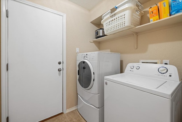 11208 Persimmon Gap Dr, Austin, TX 78717 - washroom with washing machine and dryer, light tile patterned floors, and baseboards
