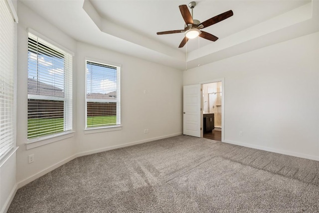 605 Bridle Creek Dr, Georgetown, TX 78626 - carpeted empty room featuring a ceiling fan, baseboards, and a tray ceiling