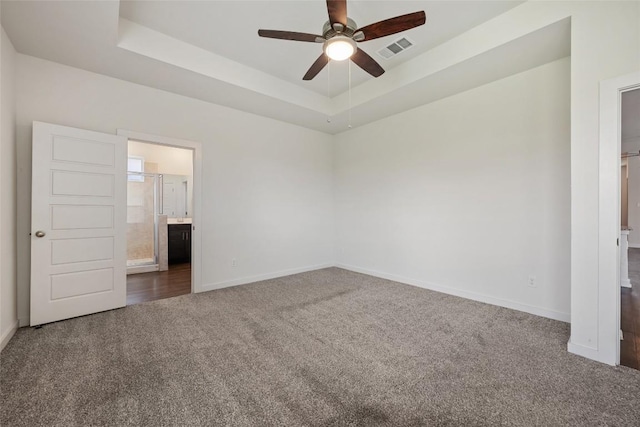 605 Bridle Creek Dr, Georgetown, TX 78626 - unfurnished bedroom with carpet, baseboards, ensuite bath, and a raised ceiling