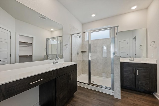 605 Bridle Creek Dr, Georgetown, TX 78626 - bathroom with a stall shower, vanity, wood finished floors, a spacious closet, and recessed lighting