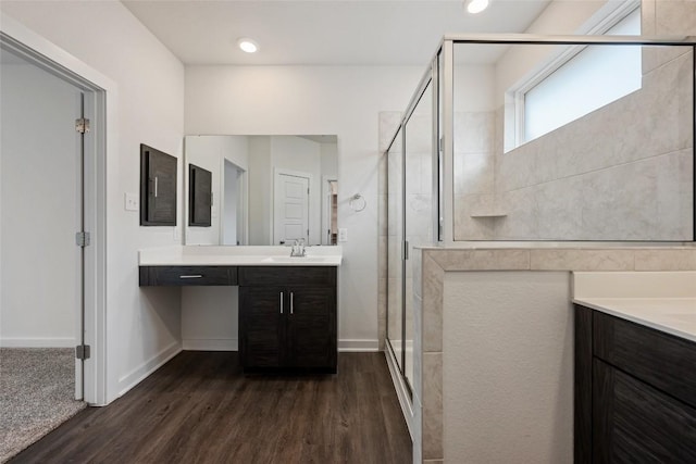 605 Bridle Creek Dr, Georgetown, TX 78626 - bathroom featuring vanity, a stall shower, wood finished floors, and baseboards