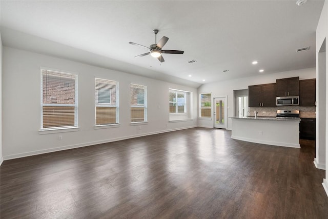 605 Bridle Creek Dr, Georgetown, TX 78626 - unfurnished living room featuring ceiling fan, dark wood-style flooring, recessed lighting, baseboards, and a sink