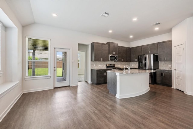 605 Bridle Creek Dr, Georgetown, TX 78626 - kitchen with appliances with stainless steel finishes, dark brown cabinets, decorative backsplash, dark wood finished floors, and recessed lighting