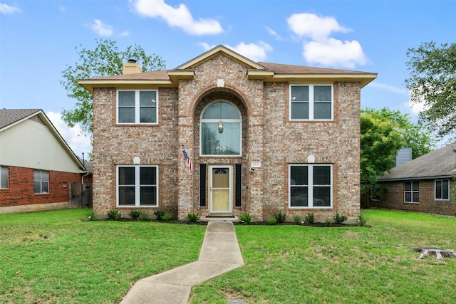 17121 Bishopsgate Dr, Pflugerville, TX 78660 - traditional-style house with a front lawn, a chimney, and brick siding