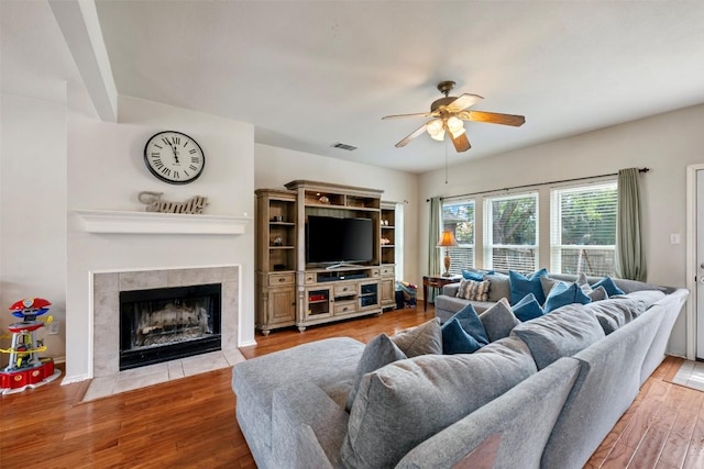 17121 Bishopsgate Dr, Pflugerville, TX 78660 - living area featuring a ceiling fan, wood finished floors, and a fireplace