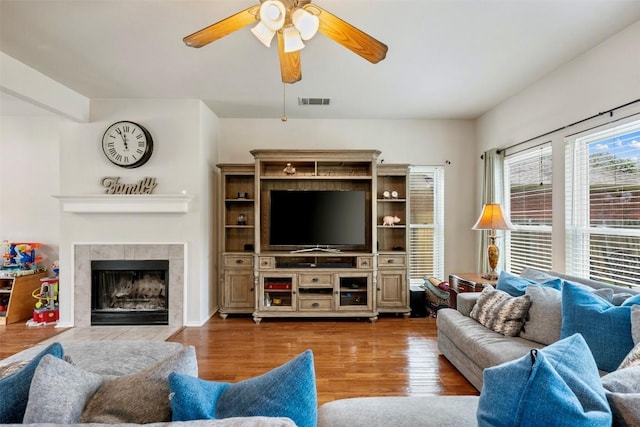 17121 Bishopsgate Dr, Pflugerville, TX 78660 - living area featuring ceiling fan, wood finished floors, and a fireplace