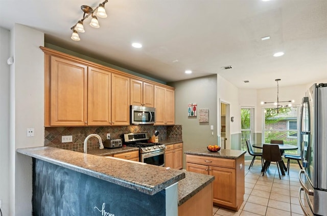 17121 Bishopsgate Dr, Pflugerville, TX 78660 - kitchen with appliances with stainless steel finishes, tasteful backsplash, a peninsula, light tile patterned floors, and recessed lighting