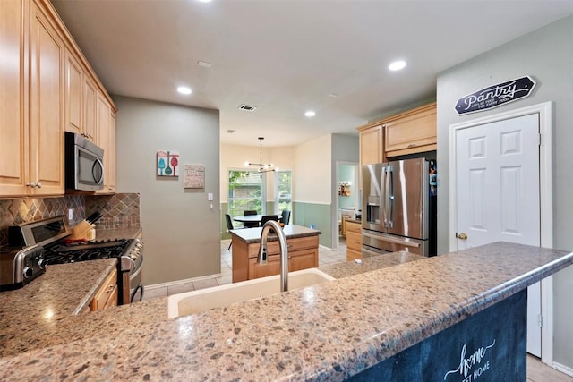17121 Bishopsgate Dr, Pflugerville, TX 78660 - kitchen with appliances with stainless steel finishes, light brown cabinetry, a sink, backsplash, and baseboards