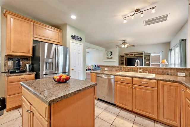 17121 Bishopsgate Dr, Pflugerville, TX 78660 - kitchen featuring appliances with stainless steel finishes, a sink, light tile patterned flooring, backsplash, and ceiling fan