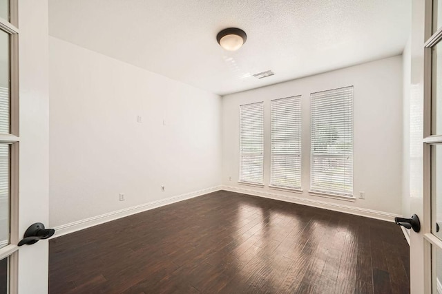 9812 Whitley Bay Dr, Austin, TX 78717 - spare room featuring dark wood-style floors, baseboards, and healthy amount of natural light
