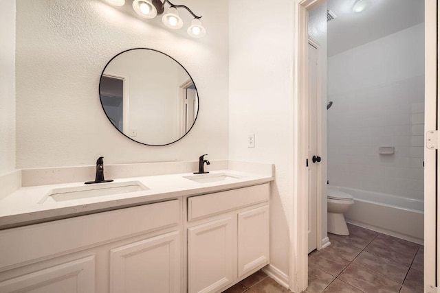 9812 Whitley Bay Dr, Austin, TX 78717 - bathroom with double vanity, tile patterned floors, toilet, and bathtub / shower combination