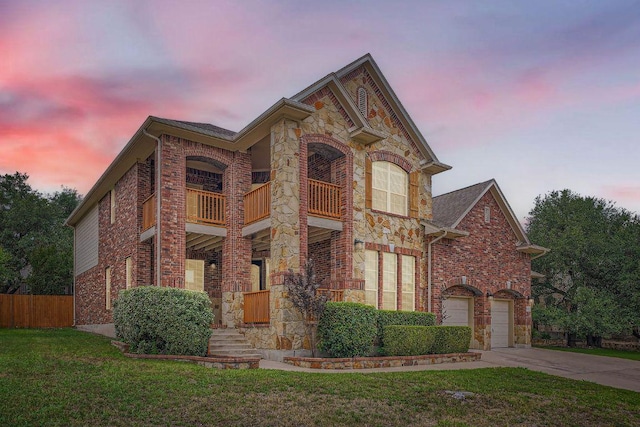 9812 Whitley Bay Dr, Austin, TX 78717 - view of front of house featuring a balcony, stone siding, driveway, brick siding, and a garage