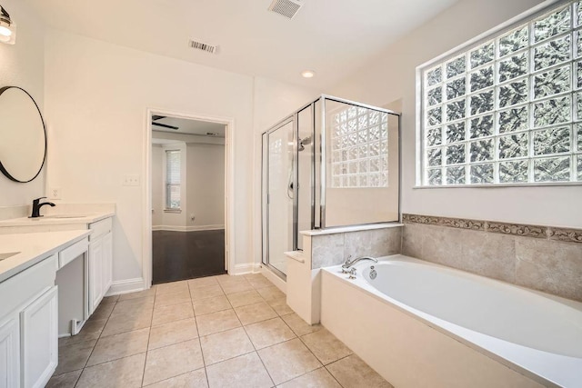 9812 Whitley Bay Dr, Austin, TX 78717 - bathroom featuring tile patterned flooring, a bath, double vanity, and a shower stall