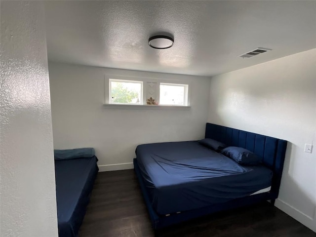 14902 Nuttall Dr, Austin, TX 78724 - bedroom featuring wood finished floors, baseboards, and a textured ceiling