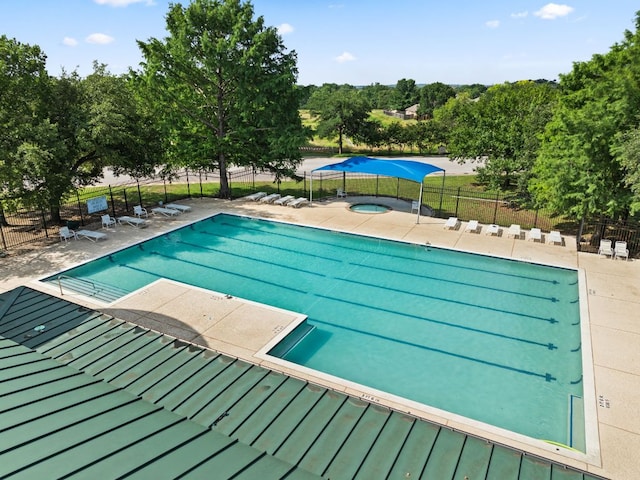 11542 Gun Fight Ln, Austin, TX 78748 - community pool featuring a hot tub, a patio area, and view of scattered trees