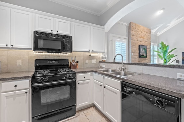 6801 Beckett Rd Unit 119L, Austin, TX 78749 - kitchen featuring black appliances, ornamental molding, white cabinets, backsplash, and arched walkways