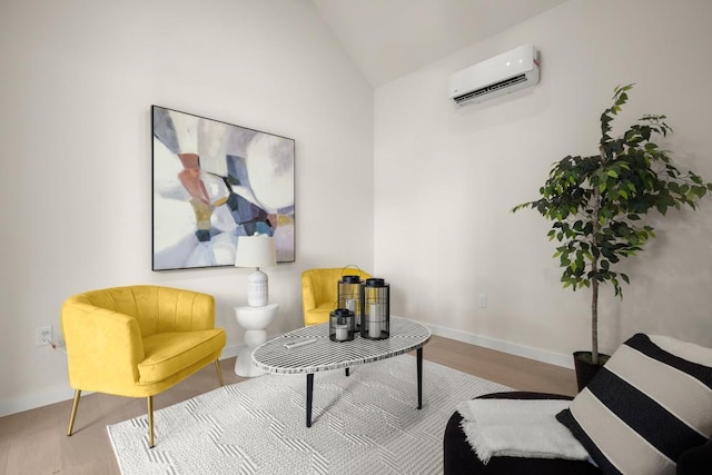 517 Tillery St Unit 3, Austin, TX 78702 - sitting room featuring an AC wall unit, vaulted ceiling, wood finished floors, and baseboards