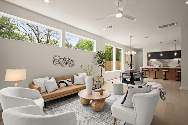 517 Tillery St Unit 3, Austin, TX 78702 - living room featuring wood finished floors, recessed lighting, a ceiling fan, and a chandelier