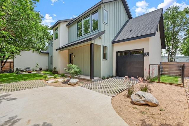 517 Tillery St Unit 3, Austin, TX 78702 - view of front of house with board and batten siding, dirt driveway, roof with shingles, a garage, and a patio