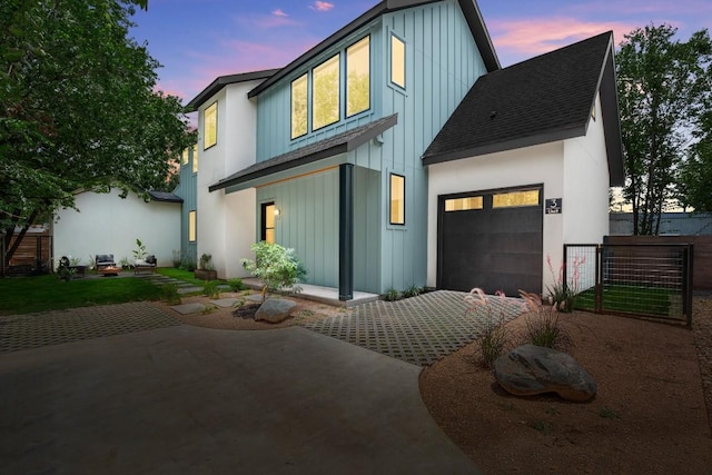 517 Tillery St Unit 3, Austin, TX 78702 - view of front facade with board and batten siding, a shingled roof, and an attached garage