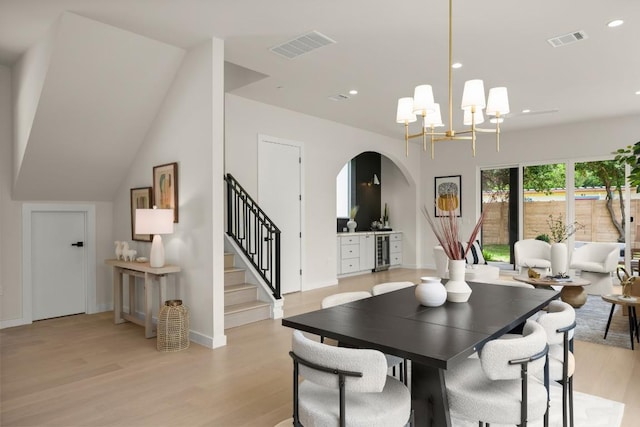 517 Tillery St Unit 3, Austin, TX 78702 - dining room featuring arched walkways, wine cooler, stairway, light wood-type flooring, and recessed lighting