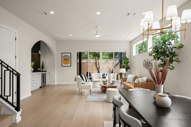 517 Tillery St Unit 3, Austin, TX 78702 - living room with wine cooler, stairs, light wood-style flooring, arched walkways, and recessed lighting