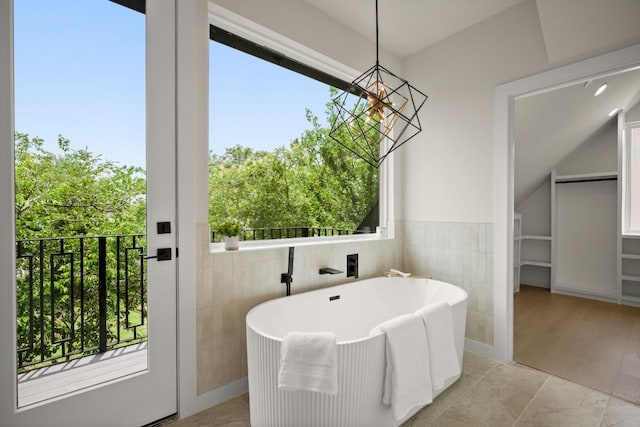 517 Tillery St Unit 3, Austin, TX 78702 - full bathroom featuring a freestanding tub, a chandelier, healthy amount of natural light, and a spacious closet