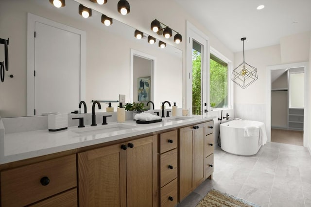 517 Tillery St Unit 3, Austin, TX 78702 - bathroom with double vanity, a soaking tub, and a spacious closet