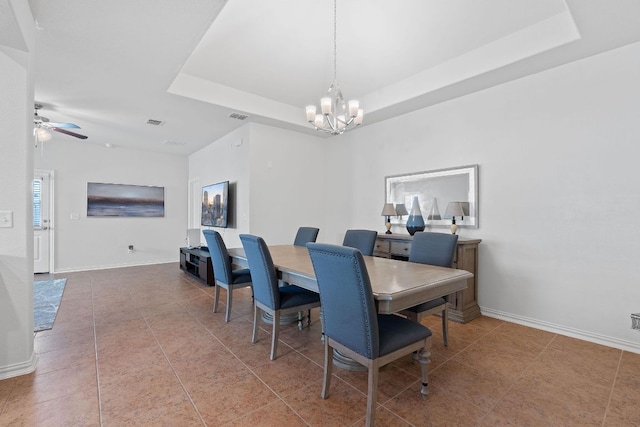 3712 Brean Down Rd, Pflugerville, TX 78660 - tiled dining area with a tray ceiling, a chandelier, ceiling fan, and baseboards