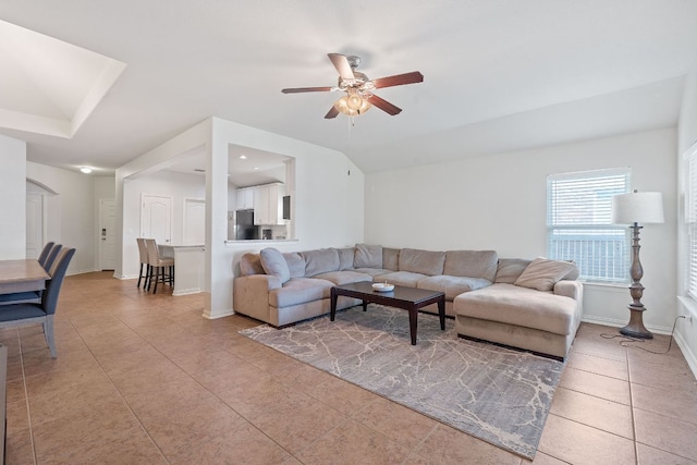 3712 Brean Down Rd, Pflugerville, TX 78660 - living area featuring ceiling fan, light tile patterned floors, baseboards, arched walkways, and vaulted ceiling