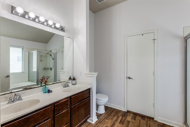 205 Tolcarne Dr, Hutto, TX 78634 - full bath featuring a stall shower, toilet, wood finished floors, double vanity, and a garden tub