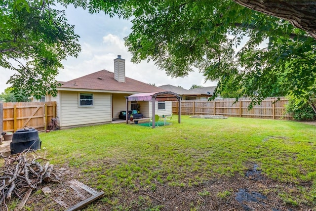 205 Tolcarne Dr, Hutto, TX 78634 - back of house featuring a chimney and a patio