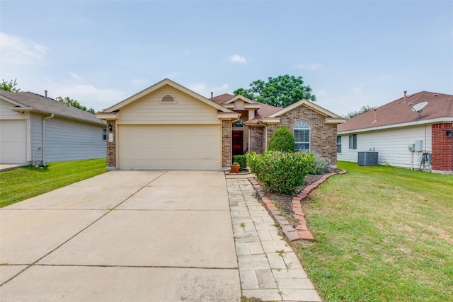 205 Tolcarne Dr, Hutto, TX 78634 - ranch-style house featuring brick siding, an attached garage, central AC, and a front yard