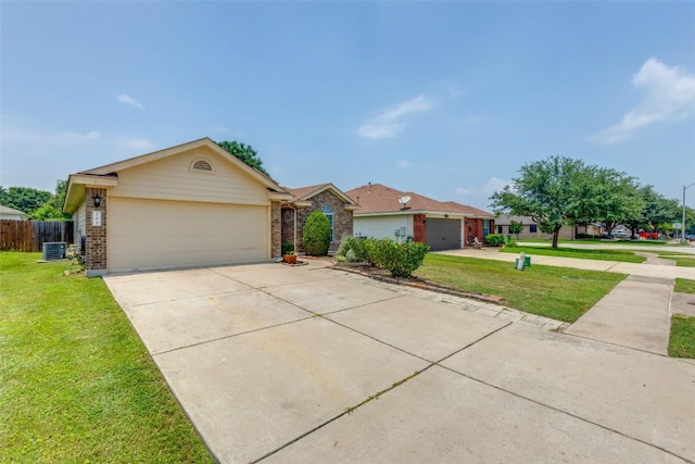 205 Tolcarne Dr, Hutto, TX 78634 - single story home featuring brick siding, a garage, driveway, and central air condition unit