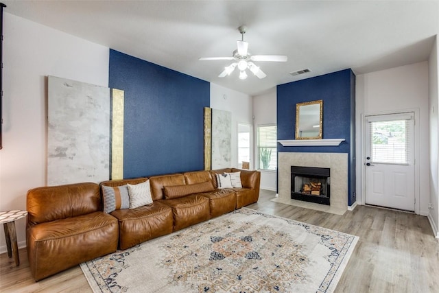205 Tolcarne Dr, Hutto, TX 78634 - living room featuring wood finished floors, a fireplace, and a ceiling fan